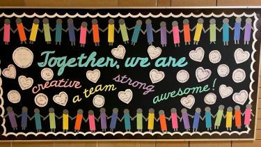 Swift_HallwayBoard-Together-we-care Hallway board with writing, paper hearts and paper pencil crayons.