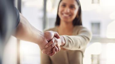 iStock Handshake Focused image of a handshake with female blurred in background