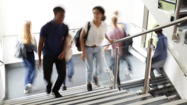 iStock Image - Motion Blur Shot Motion Blur Shot Of High School Students Walking On Stairs Between Lessons In Busy College Building